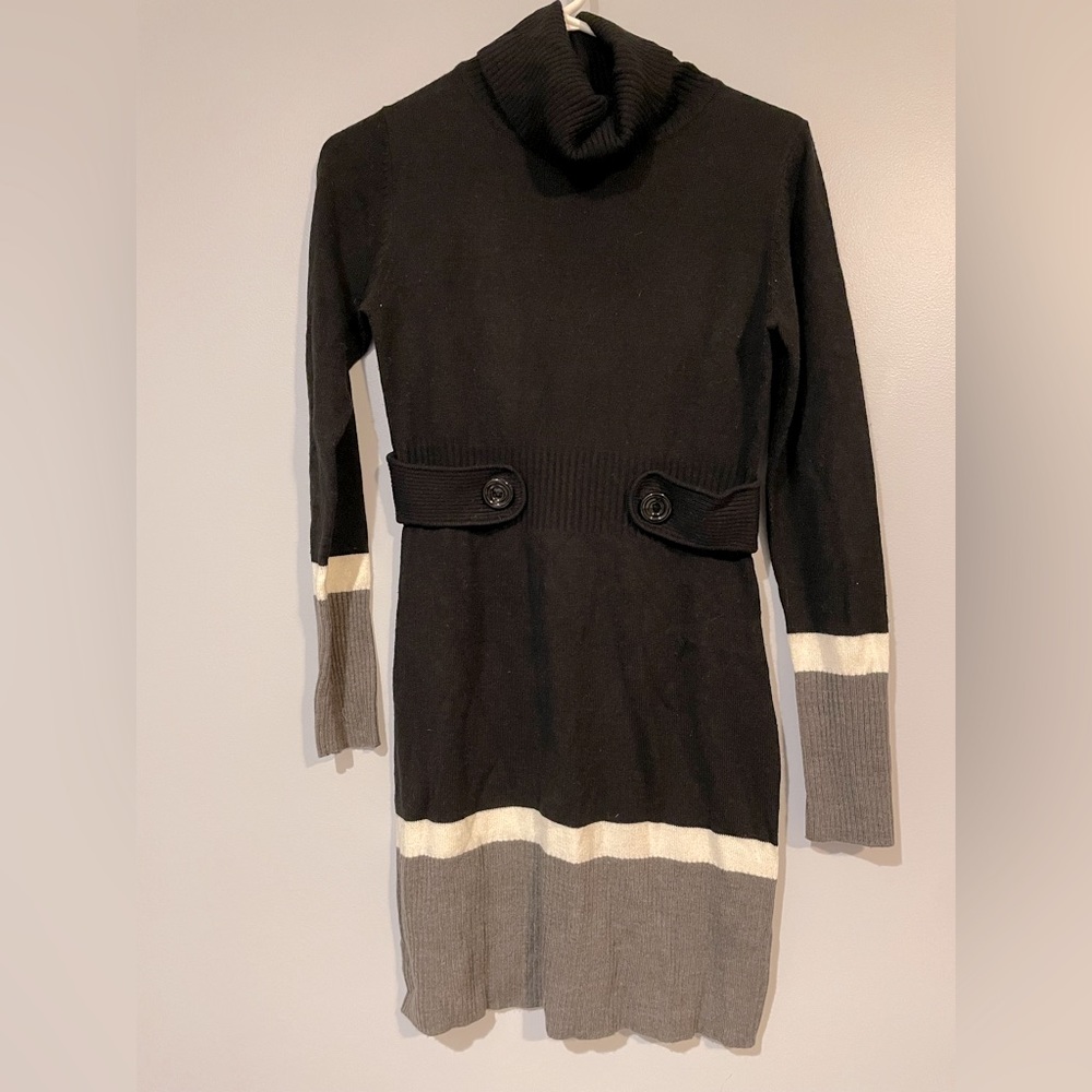 Black cowl neck sweater dress with long sleeves and gray and white accent strips